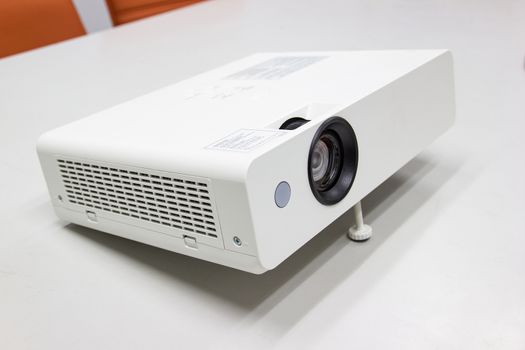 white projector for presentation for business work on table in a meeting room 