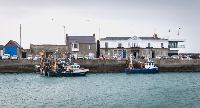 Howth near Dublin, Ireland - February 15, 2019: view of the fishing port of the city where are parked professional fishing boats on a winter day