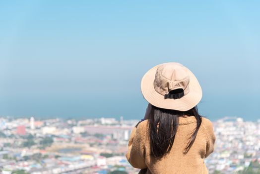 Asian pretty cute woman with hat relax at seaside city landscape viewpoint on mountain with happy and freedom emotion in concept travel, vacation, leisure in life