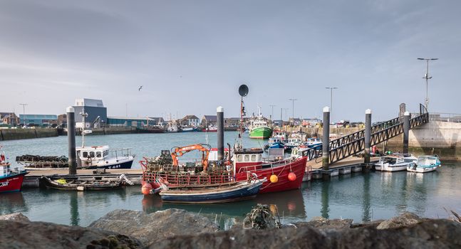 Howth near Dublin, Ireland - February 15, 2019: view of the fishing port of the city where are parked professional fishing boats on a winter day