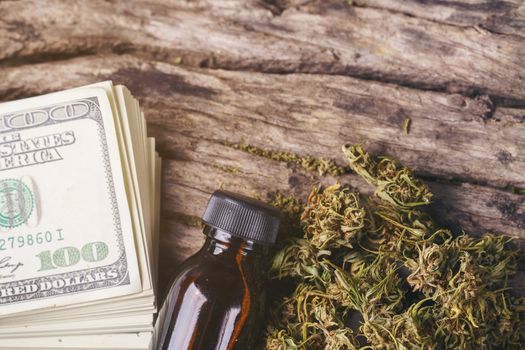 dried medical marijuana with CBD  THC extract and dollar banknote