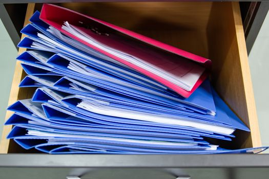 Hand of Man Search files document in a file cabinet in work office, concept business office life.