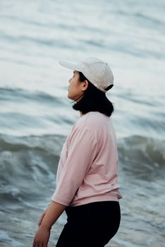 Asian woman relax at sea beach with loneliness and lonely emotion in concept travel, vacation, leisure in life