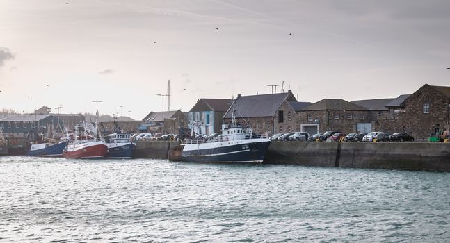 Howth near Dublin, Ireland - February 15, 2019: view of the fishing port of the city where are parked professional fishing boats on a winter day