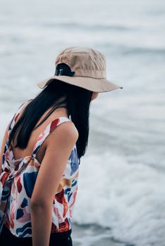 Asian woman relax at sea beach with loneliness and lonely emotion in concept travel, vacation, leisure in life