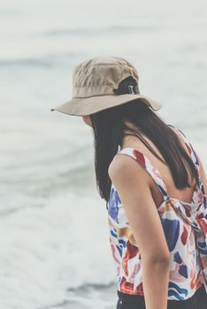 Asian woman relax at sea beach with loneliness and lonely emotion in concept travel, vacation, leisure in life