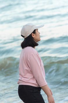 Asian woman relax at sea beach with loneliness and lonely emotion in concept travel, vacation, leisure in life
