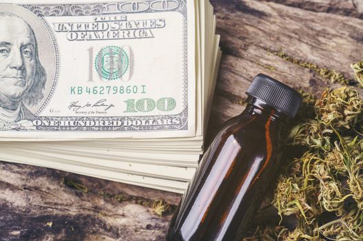 dried medical marijuana with CBD  THC extract and dollar banknote