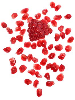 Pomegranate with scattered grain top view on white background.