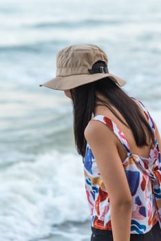 Asian woman relax at sea beach with loneliness and lonely emotion in concept travel, vacation, leisure in life