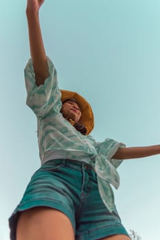 Low angle view of cute three asian women hold hands circle running round camera shot below with sky overhead in concept travel, happy and fun lifestyle, friendship. Pastel vintage style