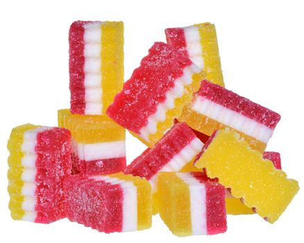 Handful of red and yellow candy close up on a white background.