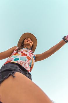 Low angle view of cute three asian women hold hands circle running round camera shot below with sky overhead in concept travel, happy and fun lifestyle, friendship. Pastel vintage style