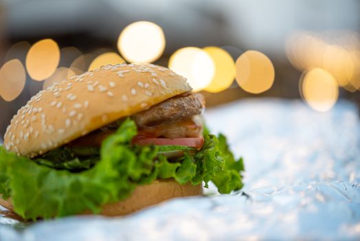 Hamburger is a fast food make from bun, meat, cheese and vegetable  in fastfood restaurant, unhealthy food or fat concept