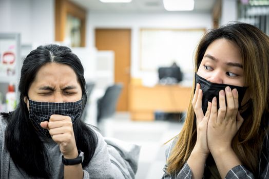 Asian pretty women wearing mask respiratory protection mask against epidemic flu covid19 or corona virus from wuhan in office with fear emotion in concept illness, outbreak, healthcare in life