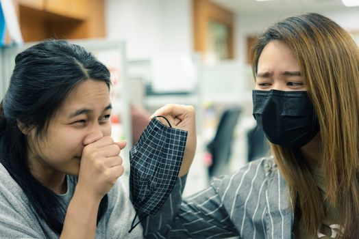 Asian pretty women wearing mask respiratory protection mask against epidemic flu covid19 or corona virus from wuhan in office with fear emotion in concept illness, outbreak, healthcare in life