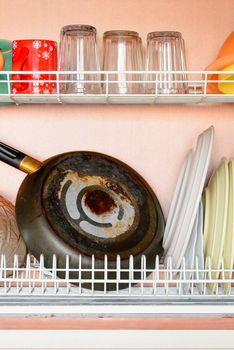 Drying dishes, pan, cups and glasses in the dish rack