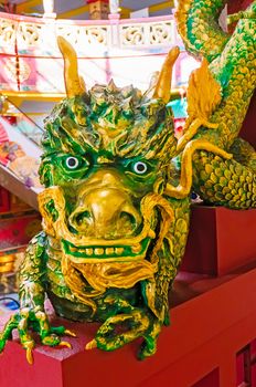 Funny green and gold Chinese dragon sculpture