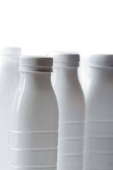 Group of white plastic milk bottle on white background