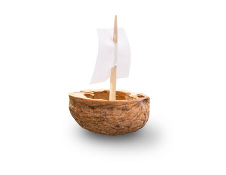 A toy made with a walnut shell with a sail, isolated on white background