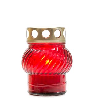 A red glass tea light with a candle inside to illuminate the Xmas evening and other celebrations