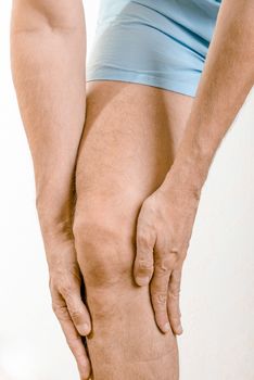 Athlete man massaging a painful  soleus and gastrocnemius muscle, under the knee, after a sport accident. It could a musculaire claquage or a muscle elongation