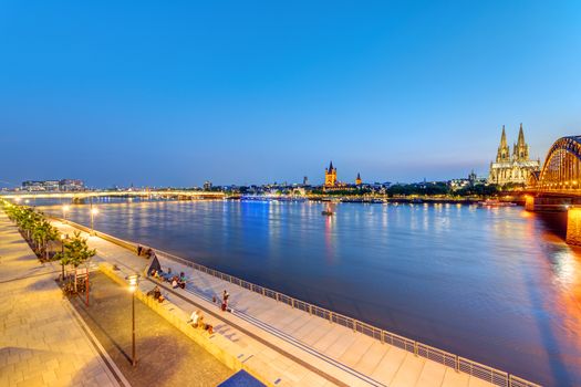 The river banks of the Rhine river in Cologne after sunset