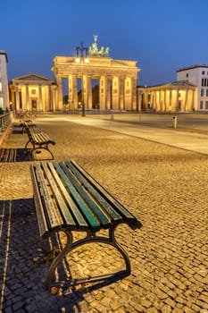 The Pariser Platz in Berlin at dawn with the illuminated Brandenburg Gate in the back