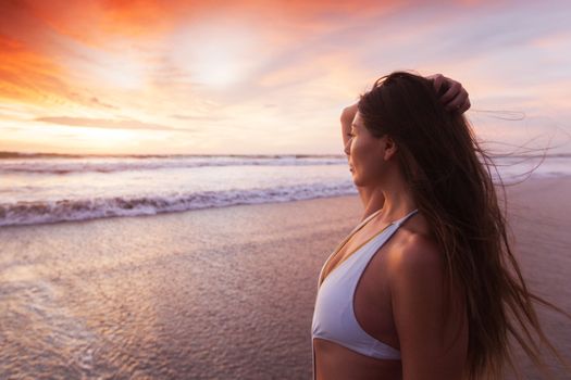 Beautiful fit woman on beach look at sunset time sea summer vacation