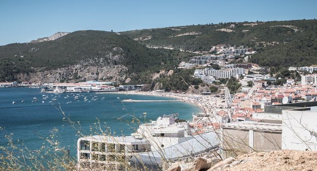 Sesimbra, Portugal - August 8, 2018: aerial overview of beaches and beach town center where tourists come to enjoy the sea on a summer day