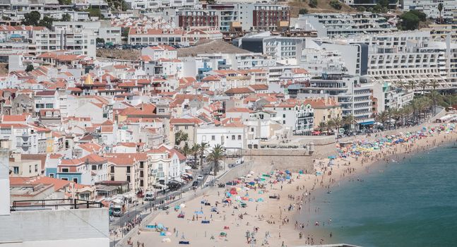 Sesimbra, Portugal - August 8, 2018: aerial overview of beaches and beach town center where tourists come to enjoy the sea on a summer day