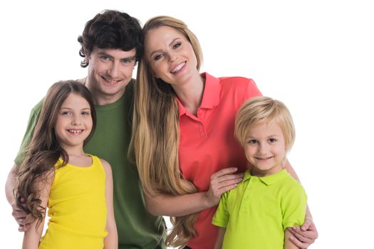 Happy young family with two children standing together embracing isolated on white background