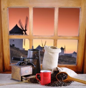 Coffee cup and coffee beans bag on window.