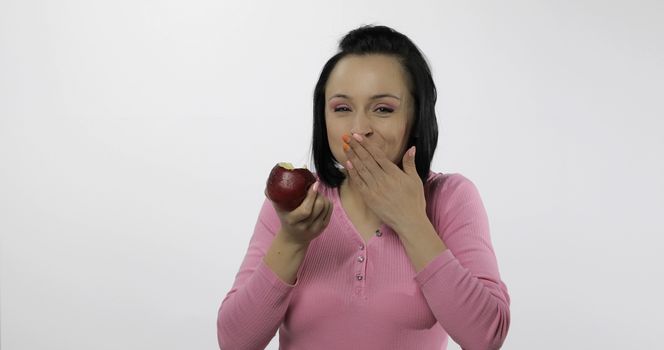 Young beautiful eating red apple. Healthy nutrition.