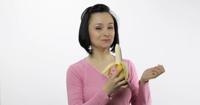 Young beautiful woman with a big banana. Healthy nutrition