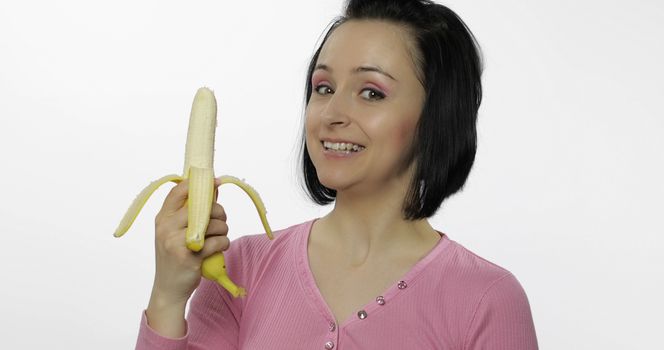 Young beautiful woman with a big banana. Healthy nutrition