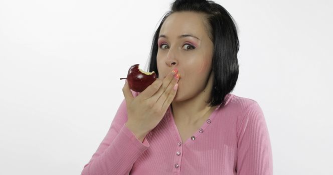 Young beautiful eating red apple. Healthy nutrition.