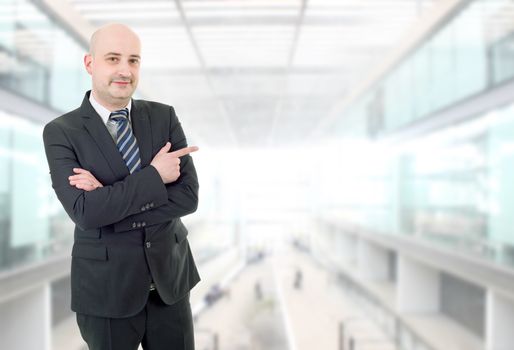 happy business man pointing, at the office