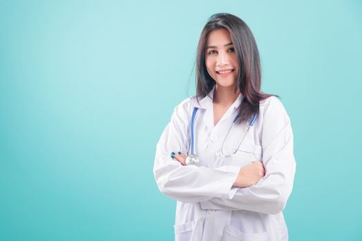 Asian doctor, happy beautiful young woman in uniform standing arms crossed against, smiling with stethoscope on blue background with copy space for text Medical health care staff service concept
