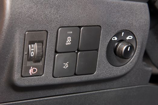Close-up of black buttons on car panel