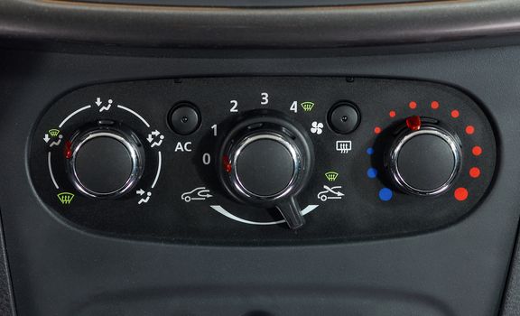 manual switches the air conditioning on the dashboard of the car