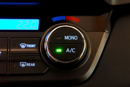 manual switches the air conditioning on the dashboard of the car