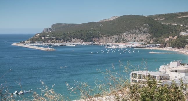 Sesimbra, Portugal - August 8, 2018: aerial overview of beaches and beach town center where tourists come to enjoy the sea on a summer day