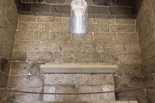 Guimaraes, Portugal - May 10, 2018: architectural detail of the Chapel of St. Michael next to the castle of Guimaraes that tourists visit on a spring day.