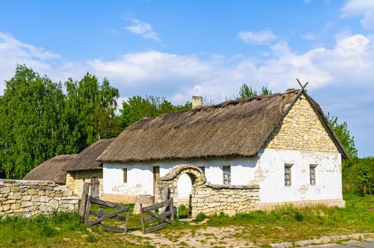 A typical Ukrainian antique house with a thatch roof, in Pirogovo near Kiev