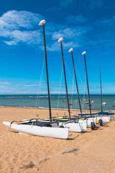 Four catamarans laid on the sand by the sea in France