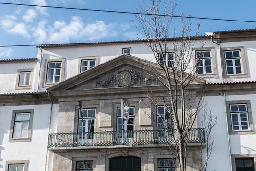 Porto, Portugal - November 30, 2018: Storefront and architectural detail of District - Offices and Lifestyle, a co working space in the historic city center on a winter day