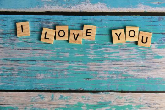 Top view I LOVE YOU word written on wood block. LOVE Wood word with copy space.