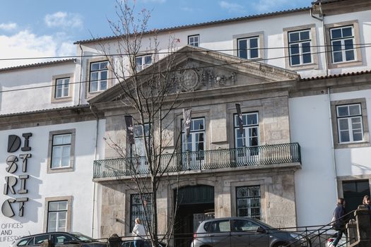 Porto, Portugal - November 30, 2018: Storefront and architectural detail of District - Offices and Lifestyle, a co working space in the historic city center on a winter day