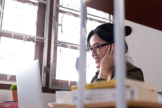 Modern young Asian woman working from home with happy, smile and relax.